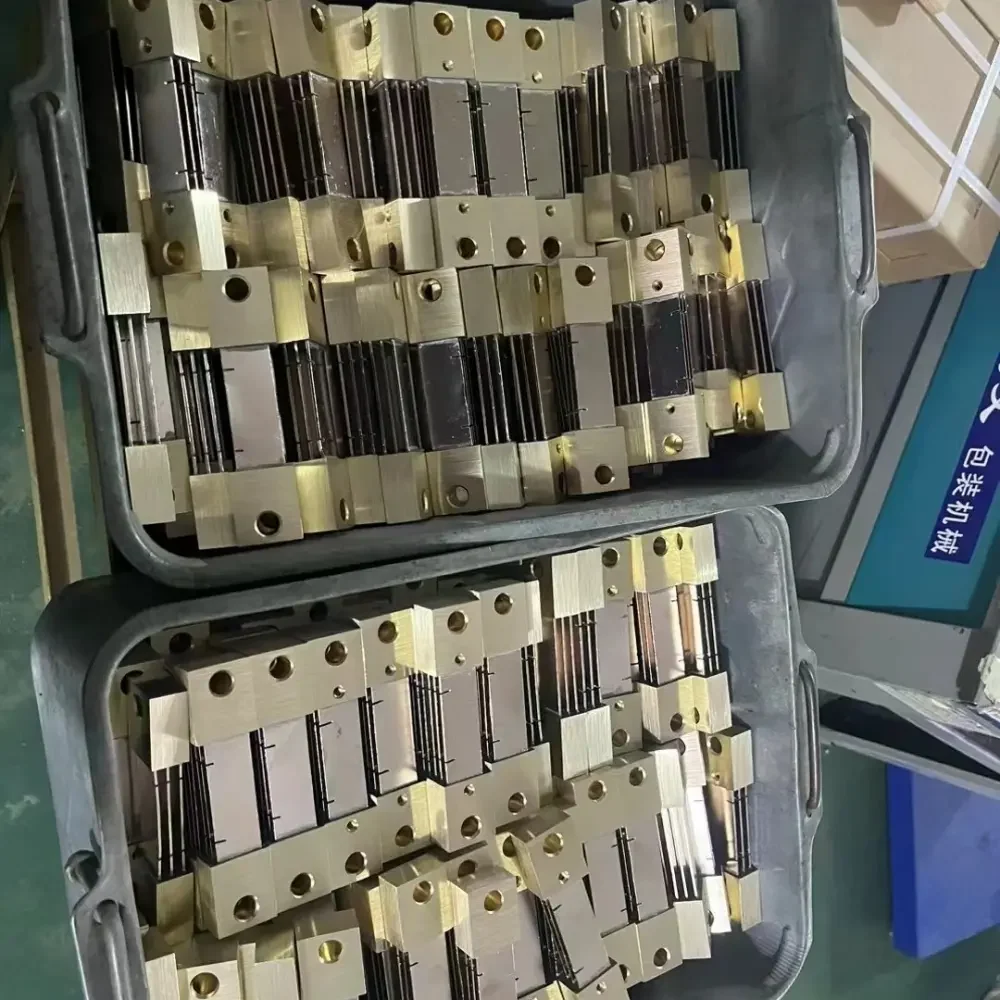 Here we see an organized array of partially assembled DC shunts, staged in a bin, ready for the next step in the manufacturing process. The components exhibit the meticulous arrangement necessary for efficient assembly line production.